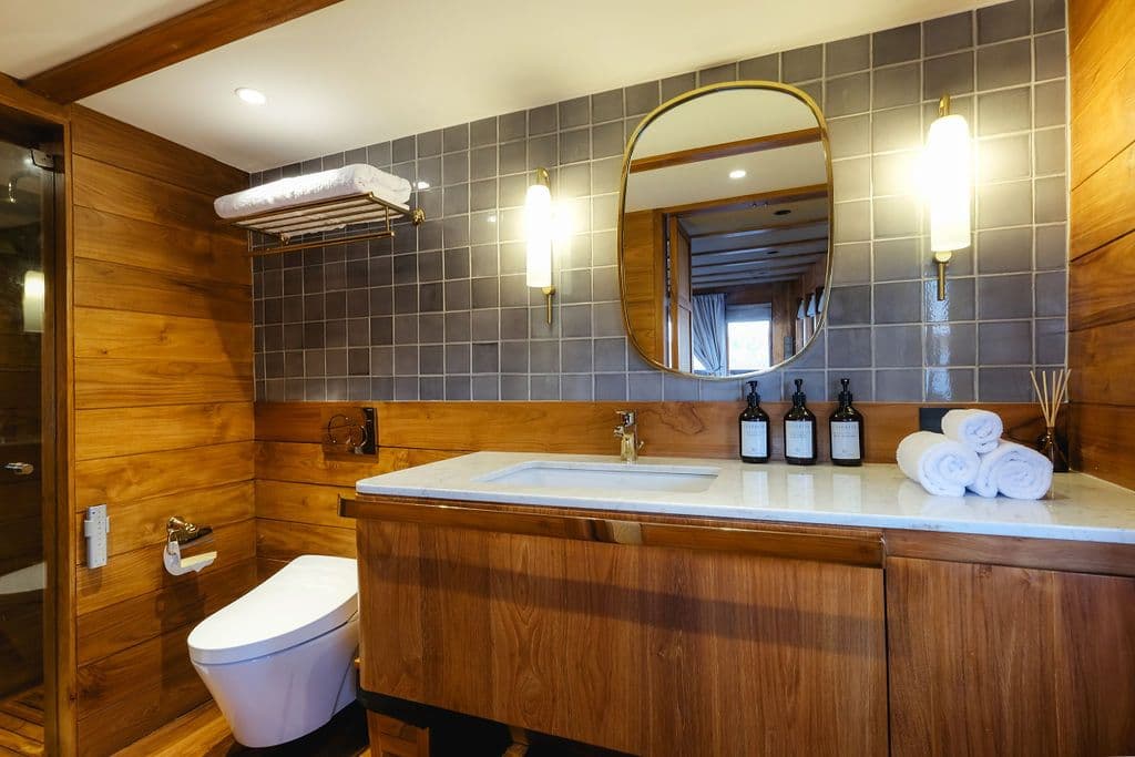 stateroom bathroom at celestia boat, wooden exterior, big mirror on the wall