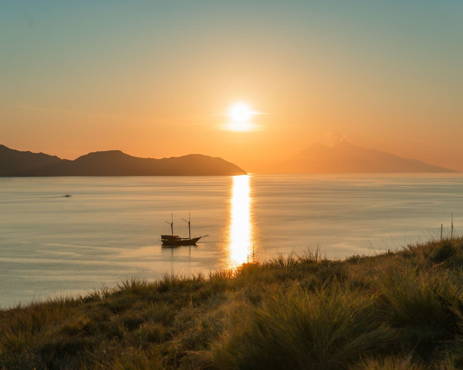 celestia boat at komodo national park, beautiful sunset view, blue and orange sky