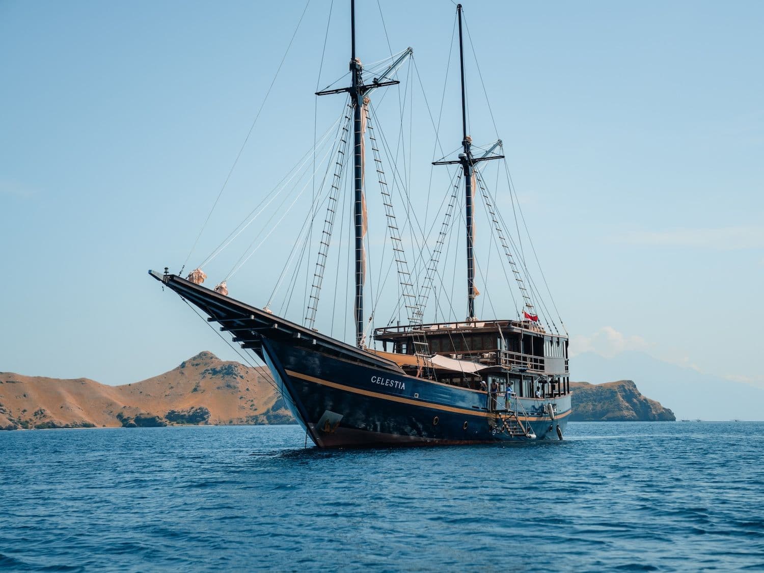 celestia boat, wooden exterior, blue sea water, komodo national park